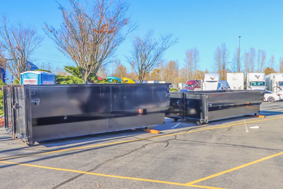 Professional dumpster rental service with roll-off container on residential driveway in Napa